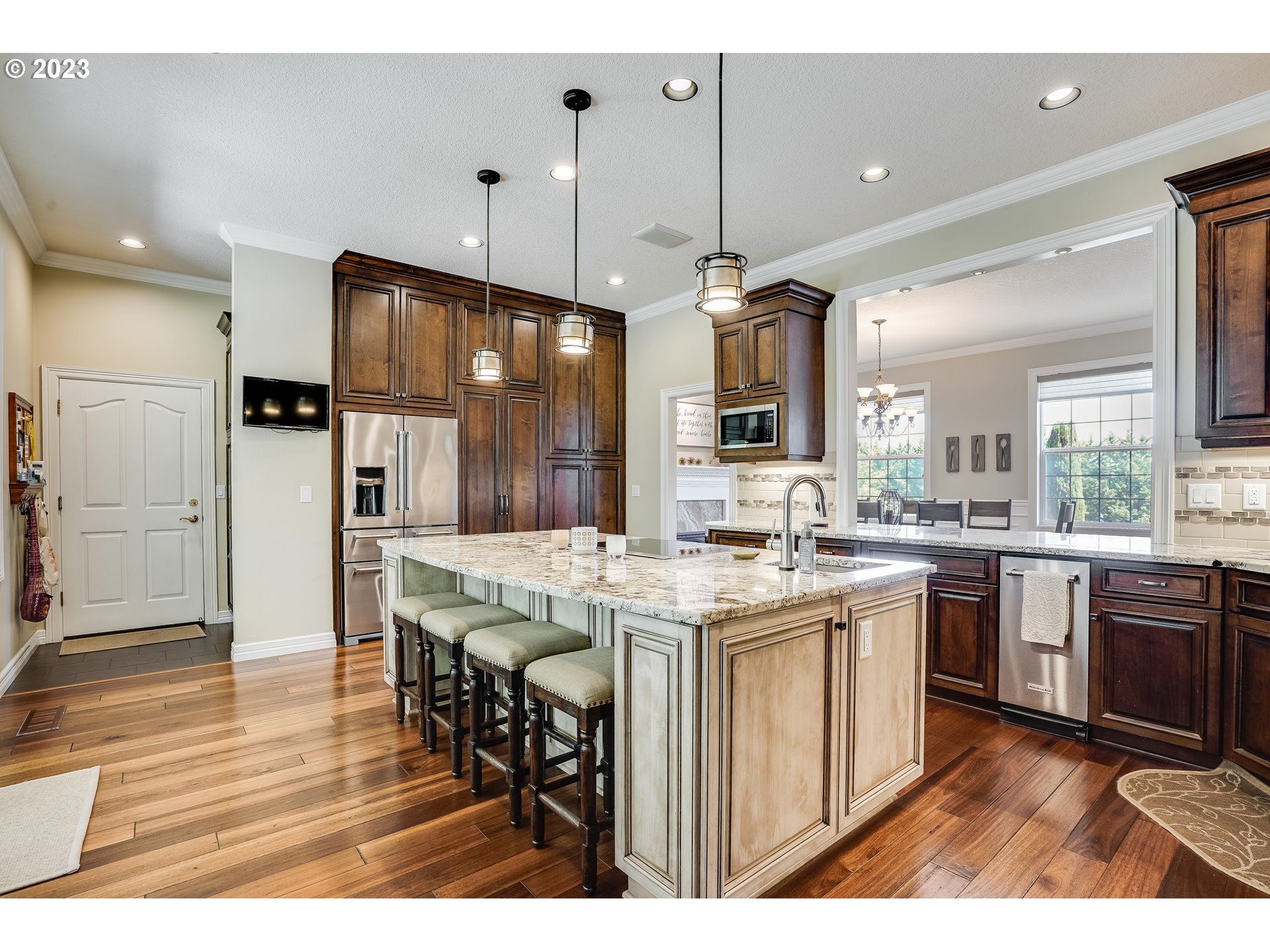 21418 Northwest 11th Avenue Ridgefield, WA 98642 - Photo 10 of 42 a kitchen with stainless steel appliances kitchen island a hardwood floor and a sink