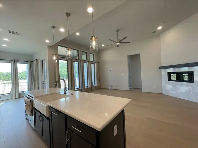 a view of kitchen with refrigerator and wooden floor