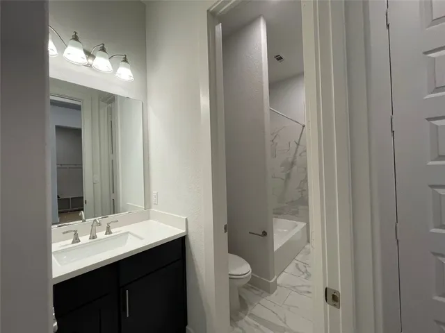 an empty room with closet and wooden floor