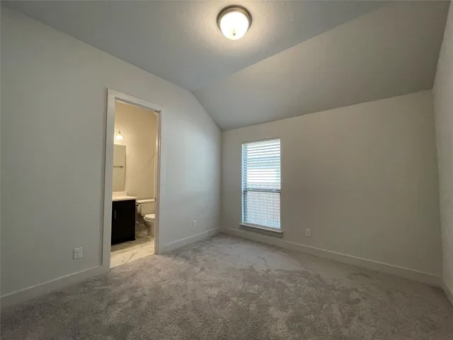 a bathroom with a shower sink vanity mirror and toilet