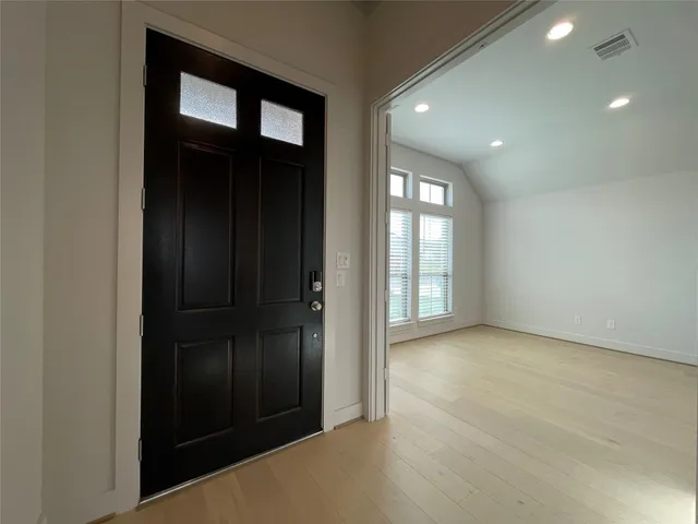 an empty room with windows and closet