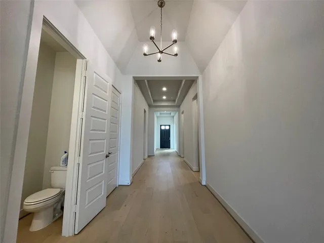 a view of hallway with wooden floor