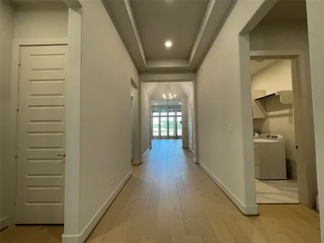 a view of hallway with wooden floor