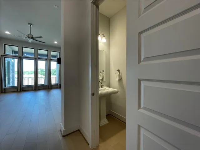 an empty room with closet and a ceiling fan