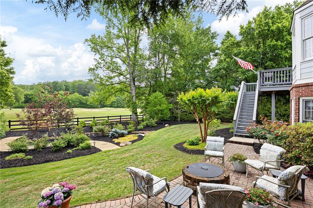 204 Golden Bell Way Canton, GA 30115 - Photo 56 of 81 a view of a chairs and table in backyard of the house