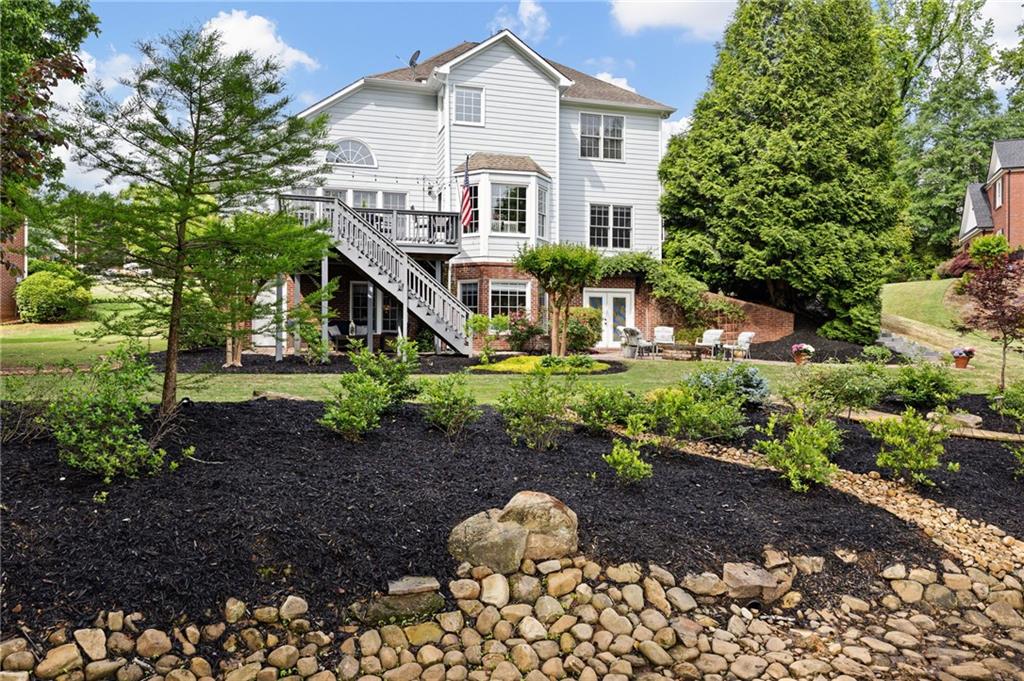 204 Golden Bell Way Canton, GA 30115 - Photo 62 of 81 a front view of a house with a yard and potted plants