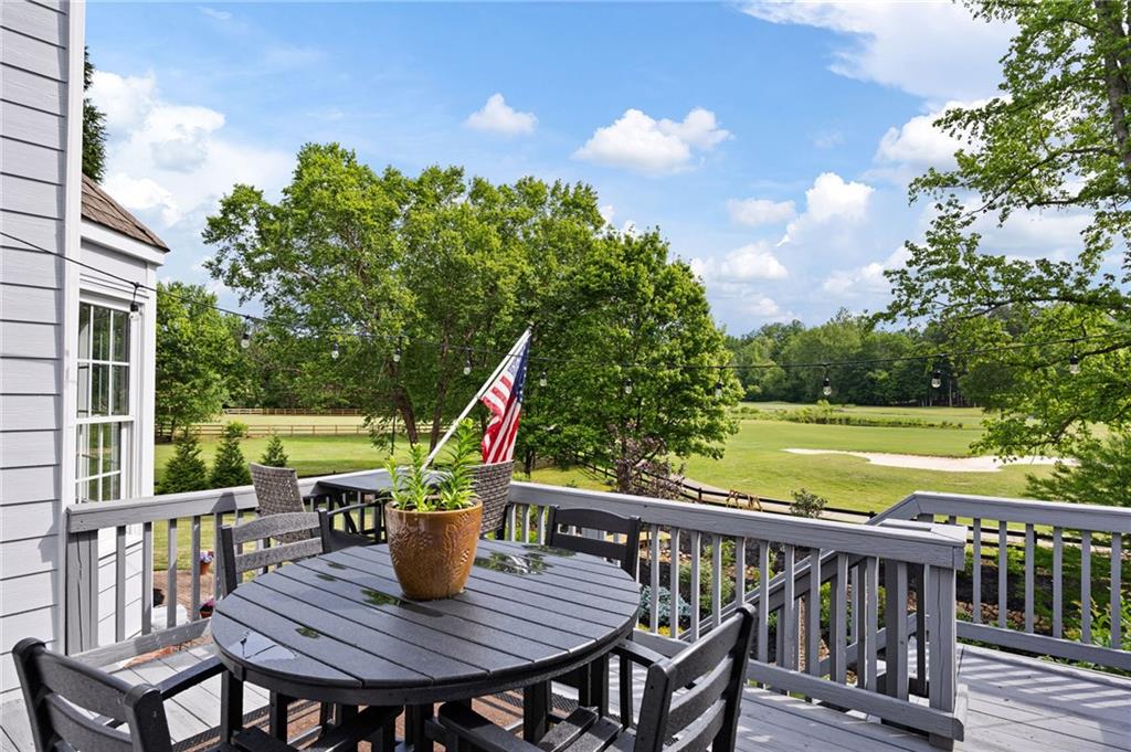 204 Golden Bell Way Canton, GA 30115 - Photo 67 of 81 a view of a deck with a table and chairs with wooden floor and fence