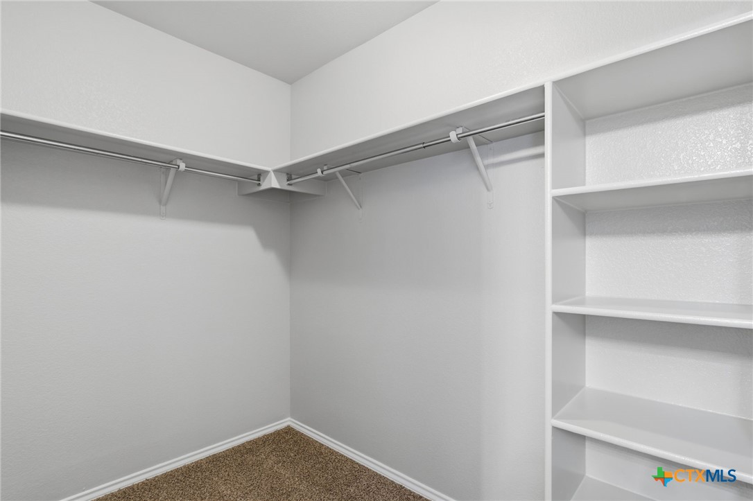 8716 Starview Street Temple, TX 76502 - Photo 20 of 36 Convenient storage area with multiple tiers of built-in shelving for easy organization.