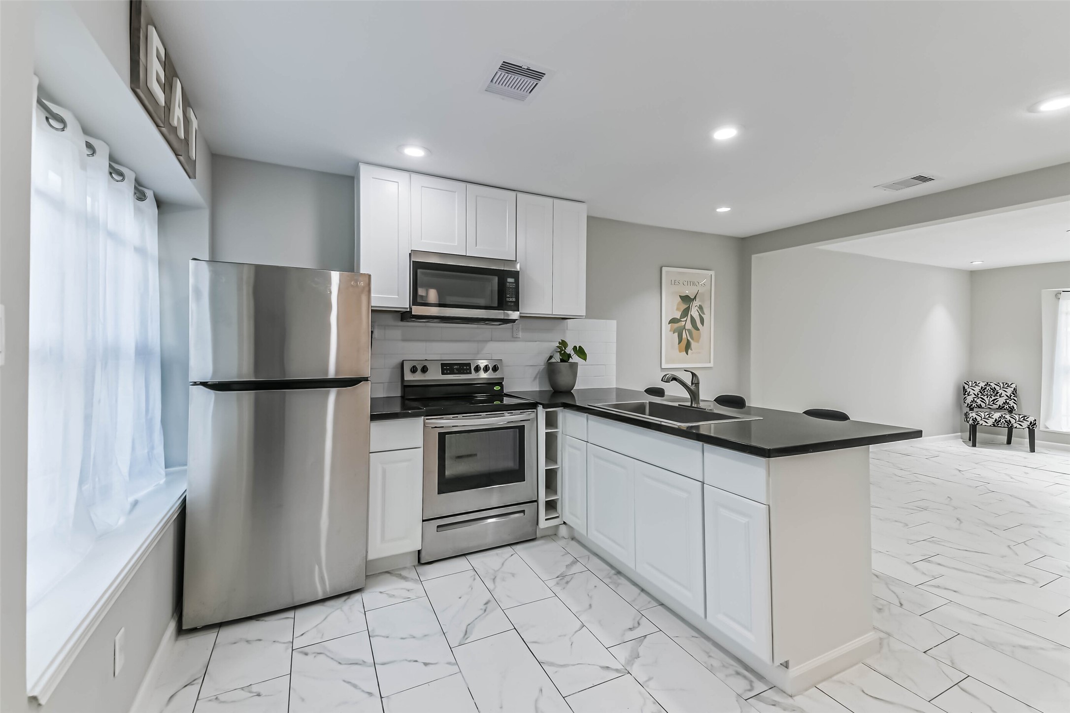 6853 Chasewood Drive Houston, TX 77489 - Photo 12 of 24 a kitchen with stainless steel appliances granite countertop a refrigerator stove a sink and a microwave