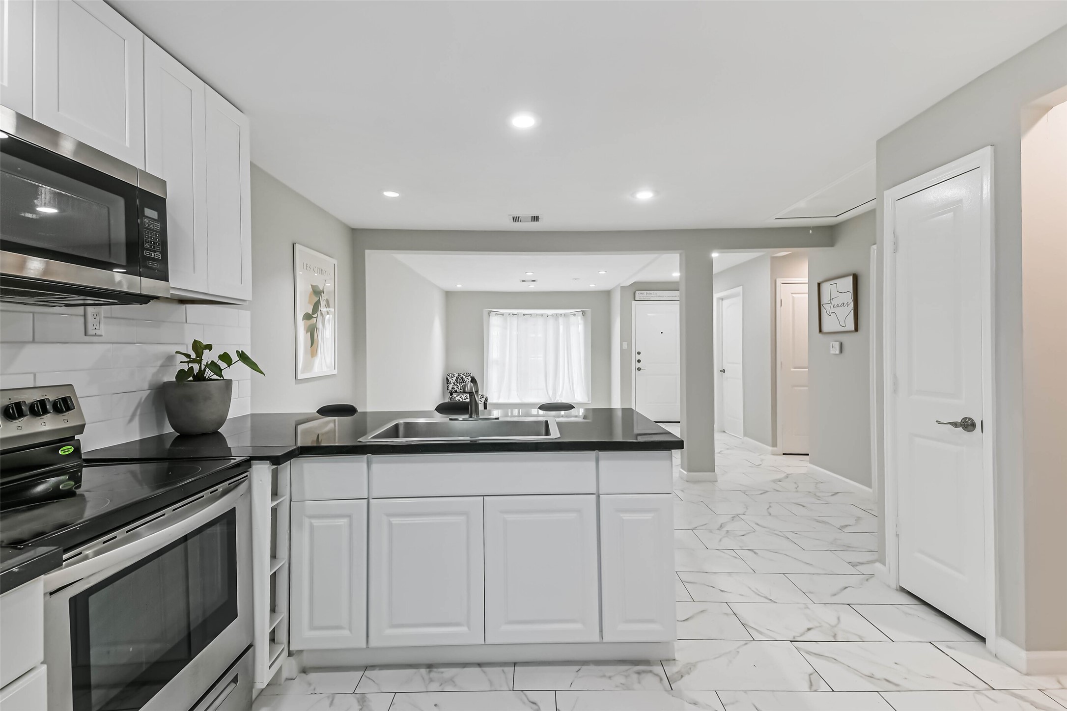 6853 Chasewood Drive Houston, TX 77489 - Photo 13 of 24 a kitchen with granite countertop a sink and a stove top oven a granite countertops