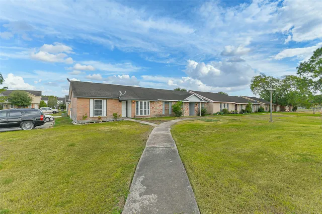 a front view of a house with a garden