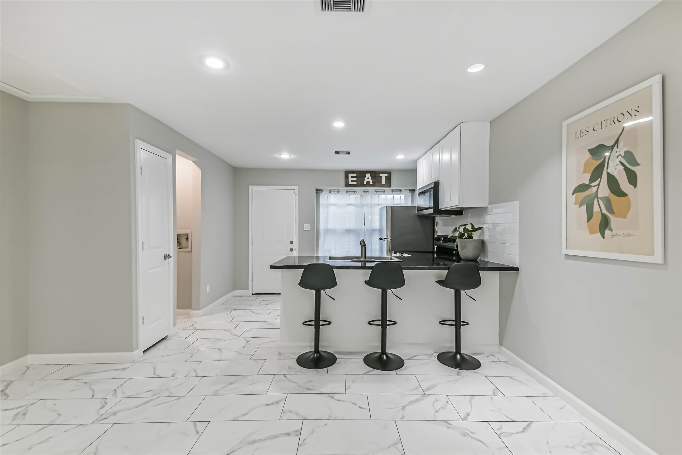 6853 Chasewood Drive Houston, TX 77489 - Photo 6 of 24 a kitchen with stainless steel appliances kitchen island granite countertop a refrigerator and white cabinets