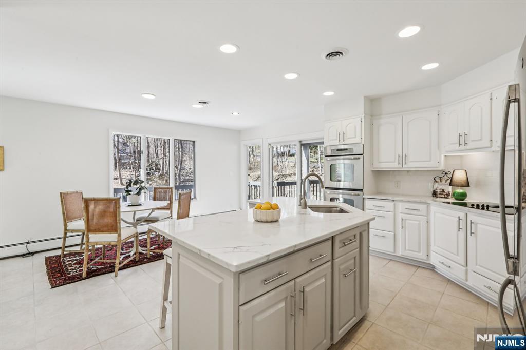 11 Carlough Road Upper Saddle River, NJ 07458 - Photo 16 of 41 a kitchen with stainless steel appliances granite countertop a sink and a refrigerator