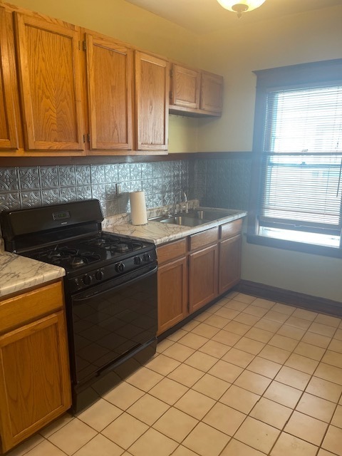 209 Circle Avenue, Unit 1 Forest Park, IL 60130 - Photo 2 of 9 a kitchen with a stove sink and cabinets