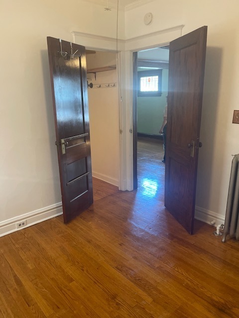 209 Circle Avenue, Unit 1 Forest Park, IL 60130 - Photo 6 of 9 a view of an empty room with closet and wooden floor