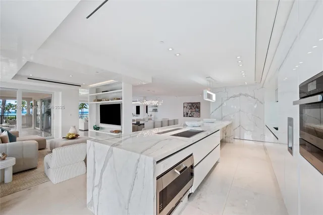 a kitchen with stainless steel appliances a sink stove and cabinets