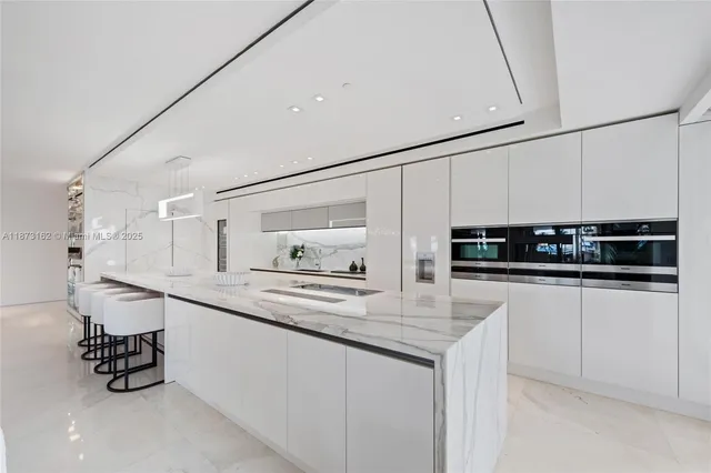 a kitchen with a table chairs stove and refrigerator