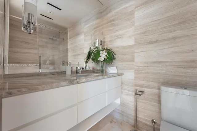 a spacious bedroom with a bed a mirror and a window