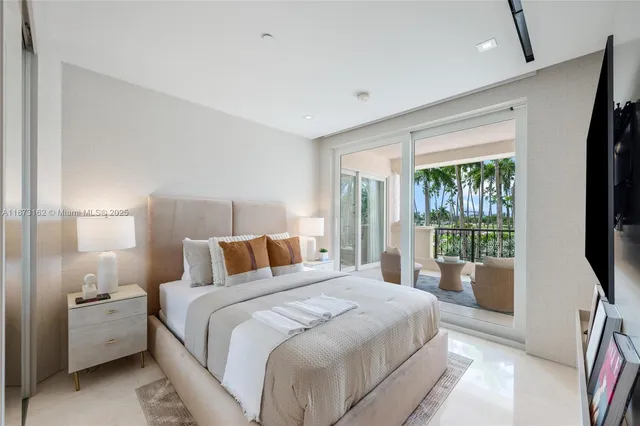 a bedroom with a flat screen television and a bed