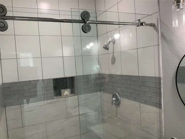 a bathroom with a granite countertop sink a toilet and a mirror