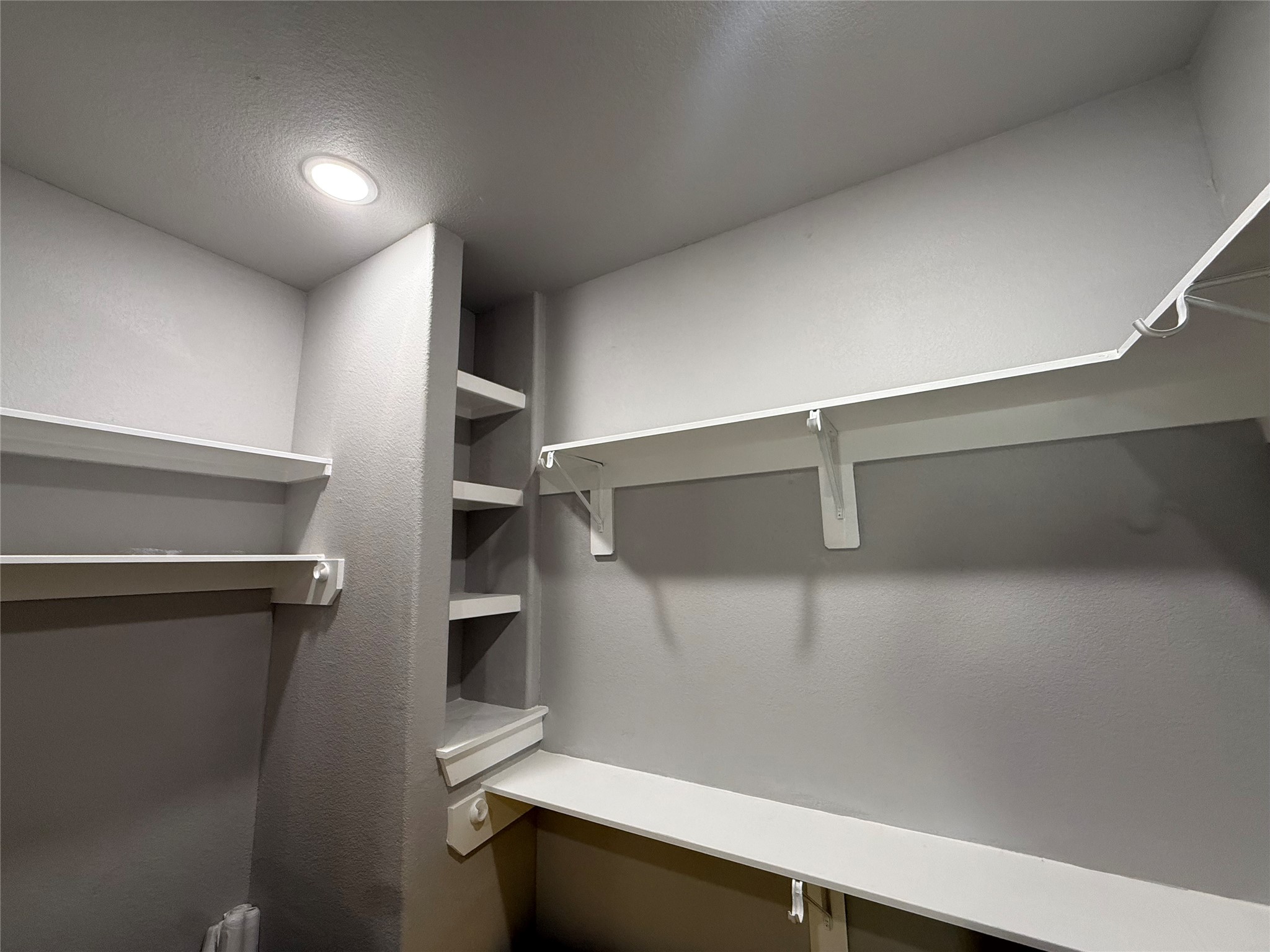 215 South 7th Street Beasley, TX 77417 - Photo 13 of 16 a view of walk in closet with empty racks