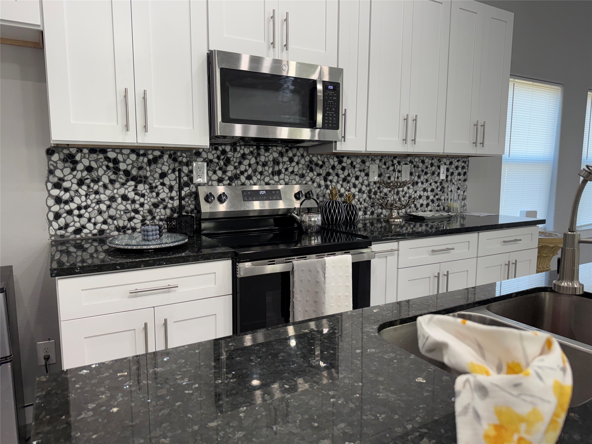 215 South 7th Street Beasley, TX 77417 - Photo 8 of 16 a kitchen with a sink a stove and cabinets