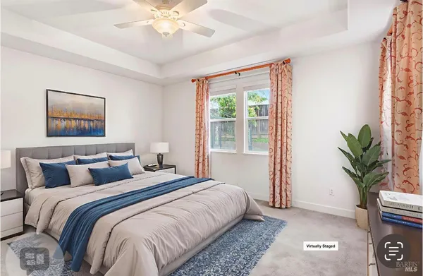a bedroom with a large bed and a potted plant