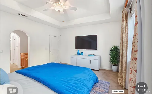 a bedroom with a bed and a flat screen tv