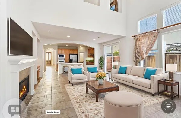 a living room with fireplace furniture and a flat screen tv