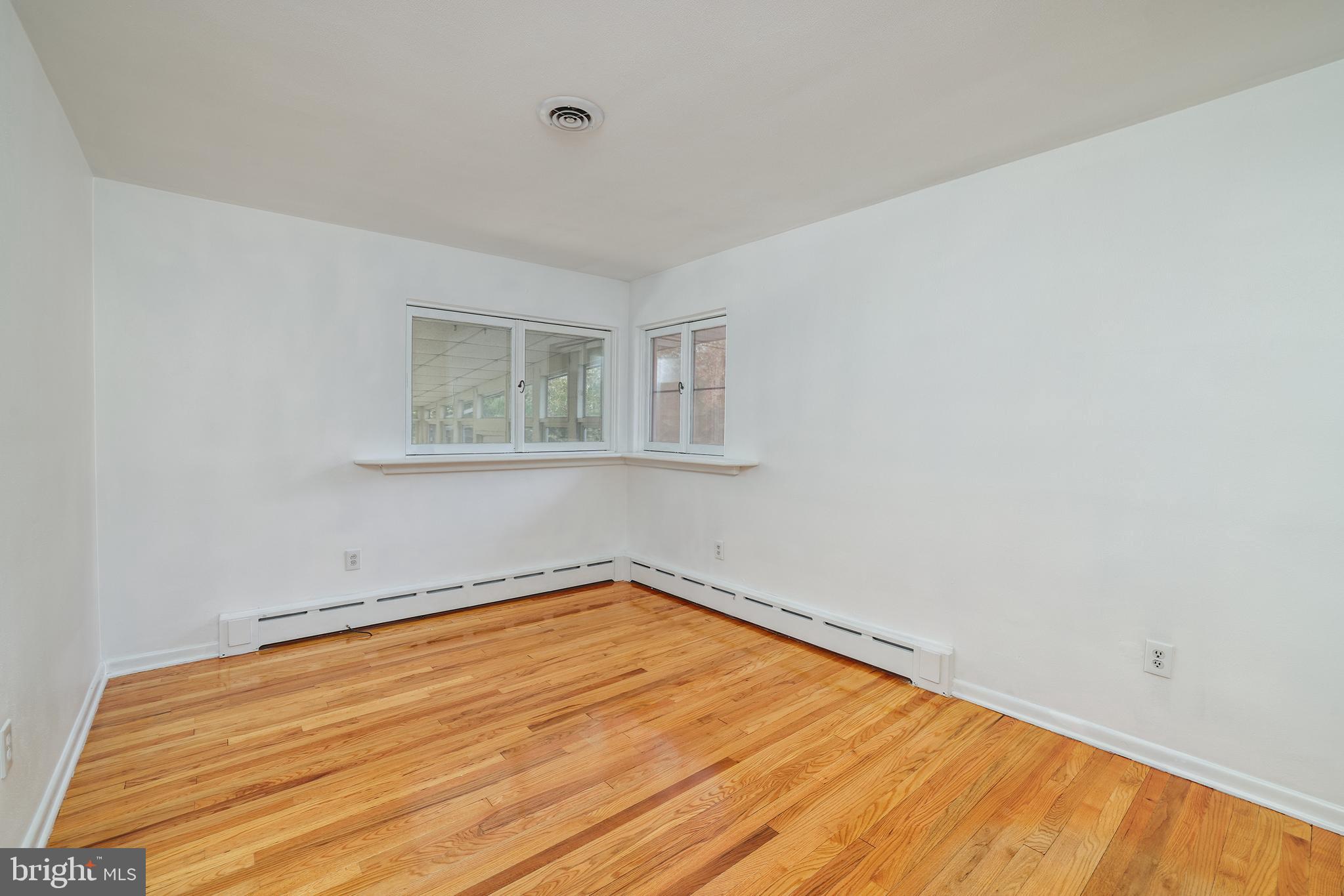 2627 Pennington Road Pennington, NJ 08534 - Photo 19 of 31 a view of a room with wooden floor and a window