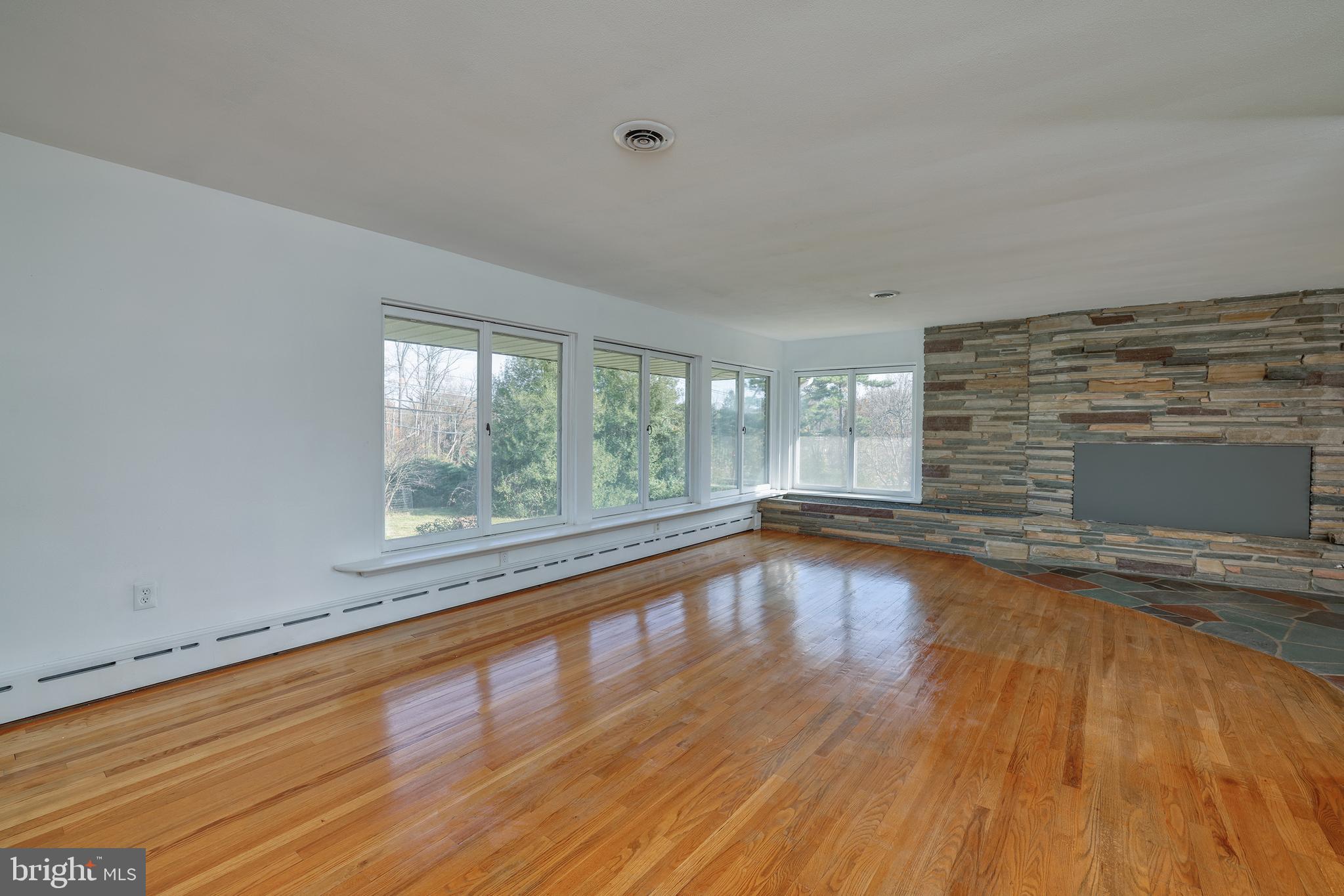 2627 Pennington Road Pennington, NJ 08534 - Photo 9 of 31 a view of empty room with wooden floor and fan