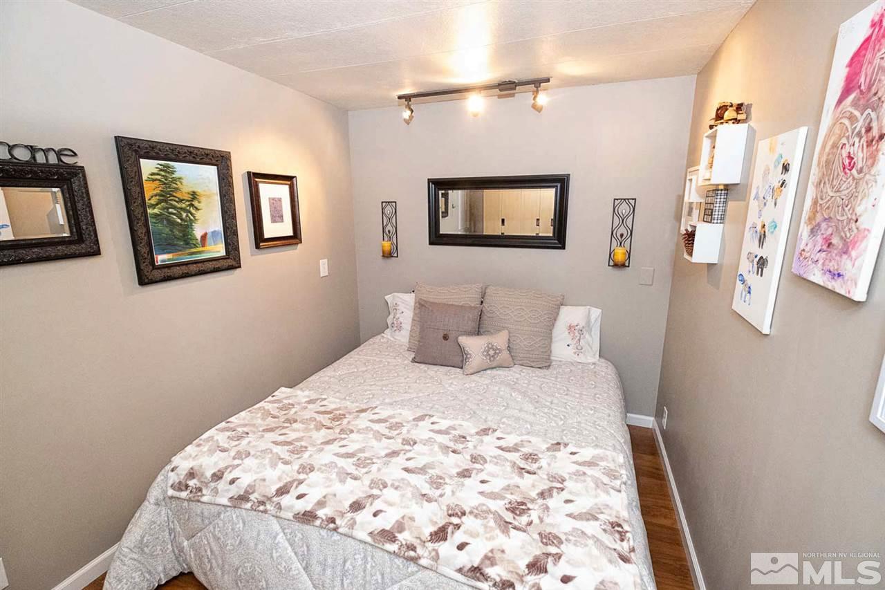 200 Gemini Circle Reno, NV 89521 - Photo 13 of 31 a bedroom with a bed and a painting on the wall