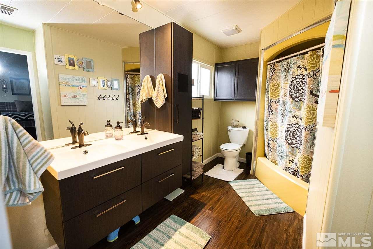 200 Gemini Circle Reno, NV 89521 - Photo 18 of 31 a bathroom with a double vanity sink toilet and shower