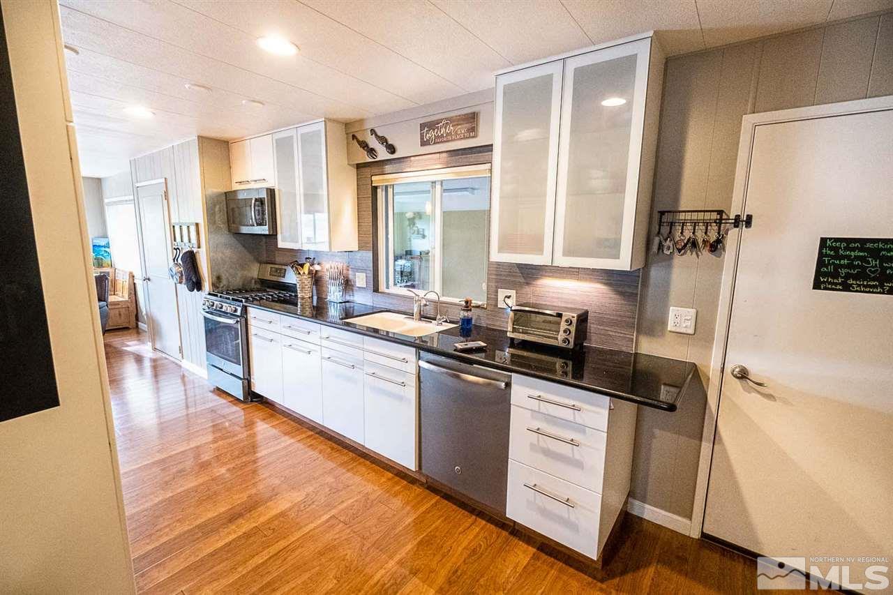 200 Gemini Circle Reno, NV 89521 - Photo 4 of 31 a kitchen with granite countertop a sink appliances cabinets and furniture