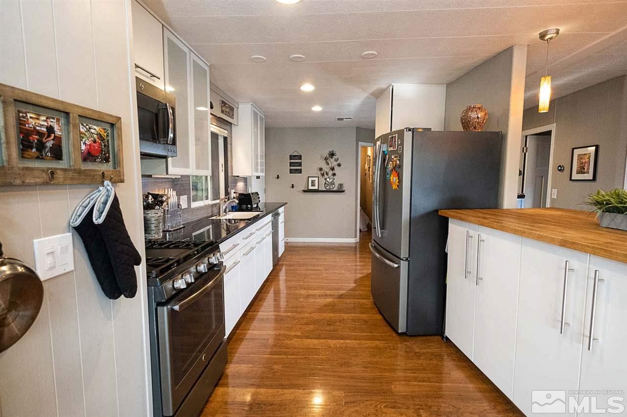 200 Gemini Circle Reno, NV 89521 - Photo 5 of 31 a kitchen with stainless steel appliances granite countertop a refrigerator a stove and a sink