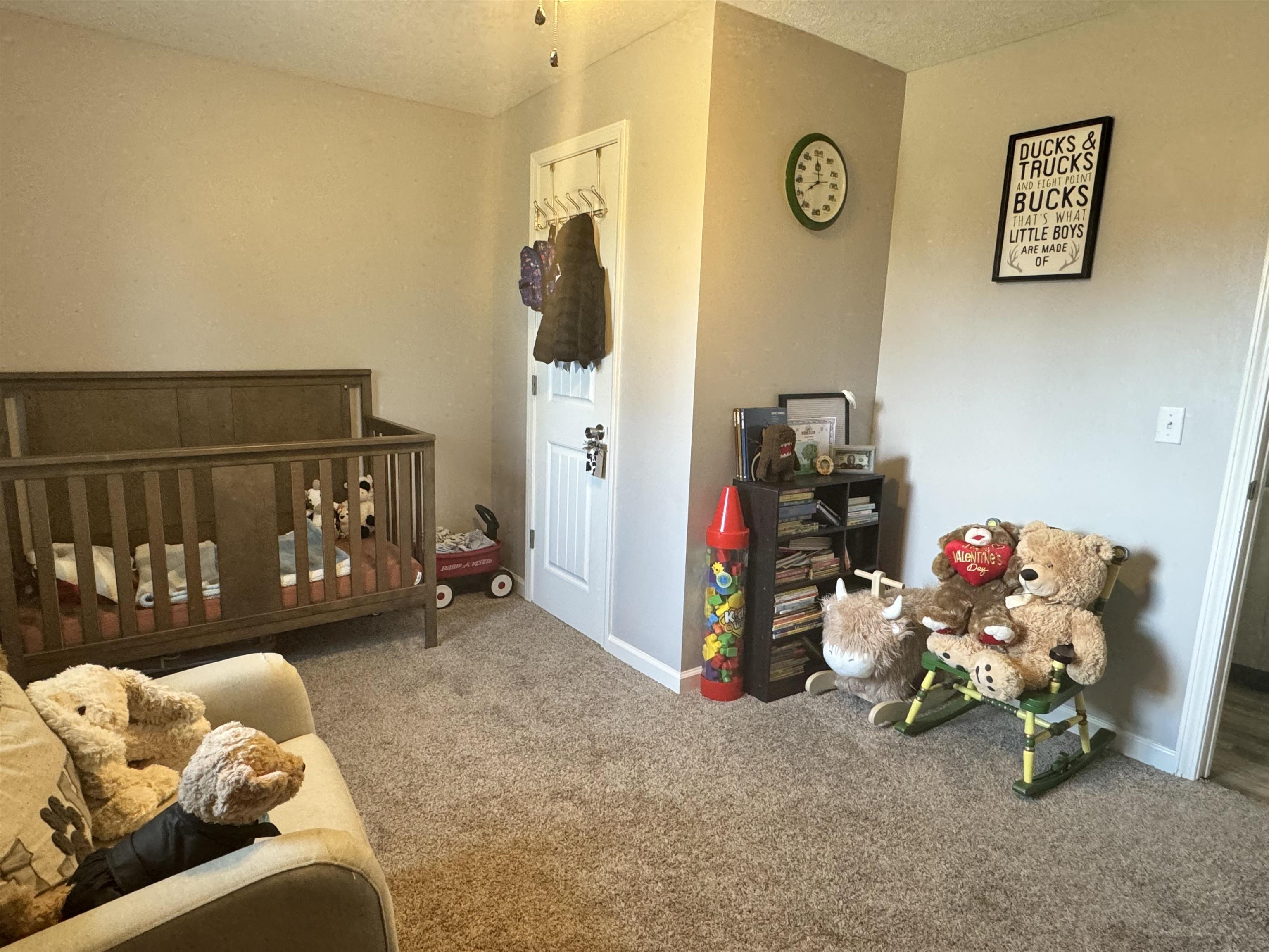 780 Ammons Road Selmer, TN 38375 - Photo 11 of 21 Carpeted bedroom with a textured ceiling and a nursery area