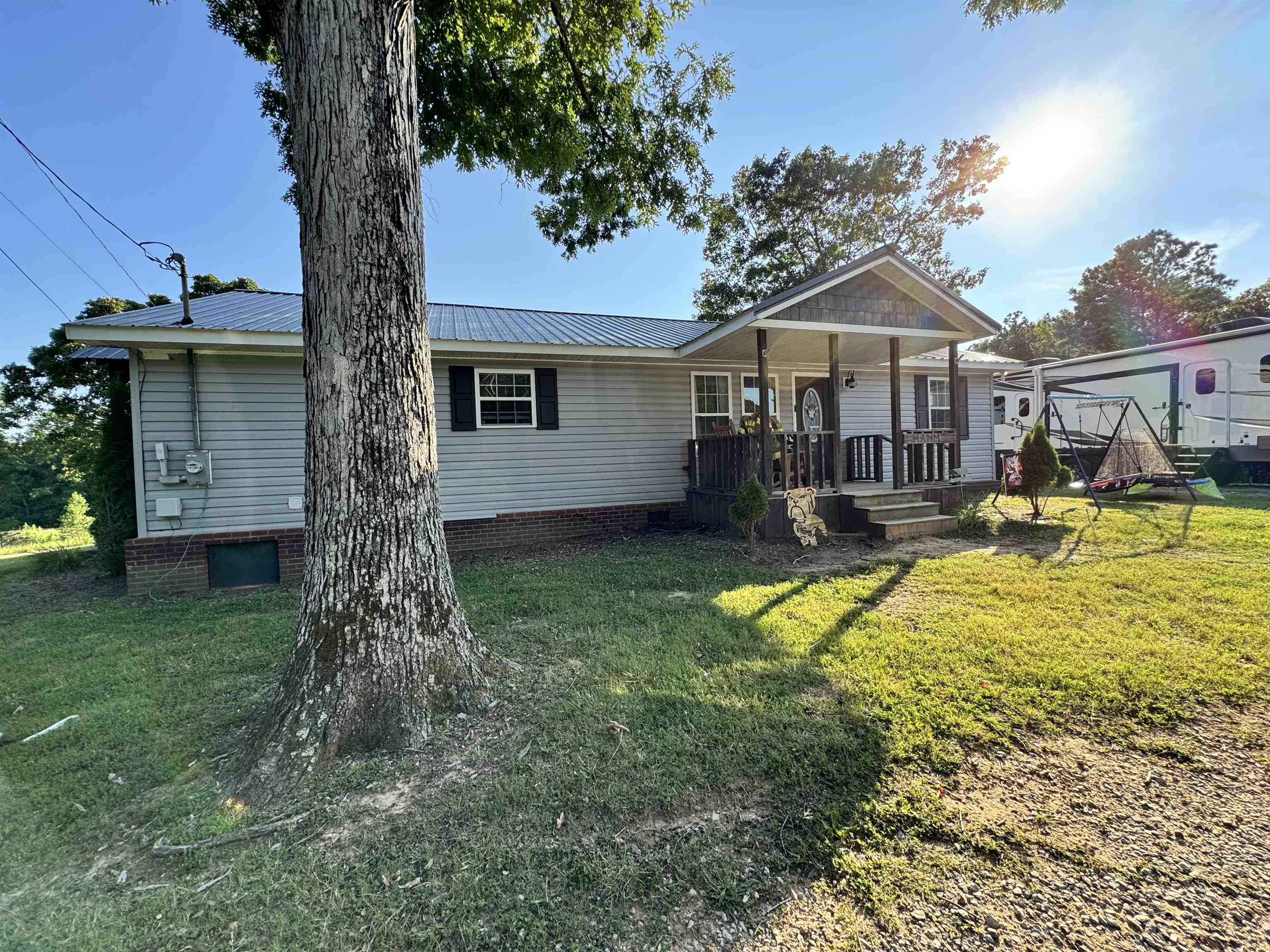 780 Ammons Road Selmer, TN 38375 - Photo 21 of 21 Rear view of house with covered porch and a yard