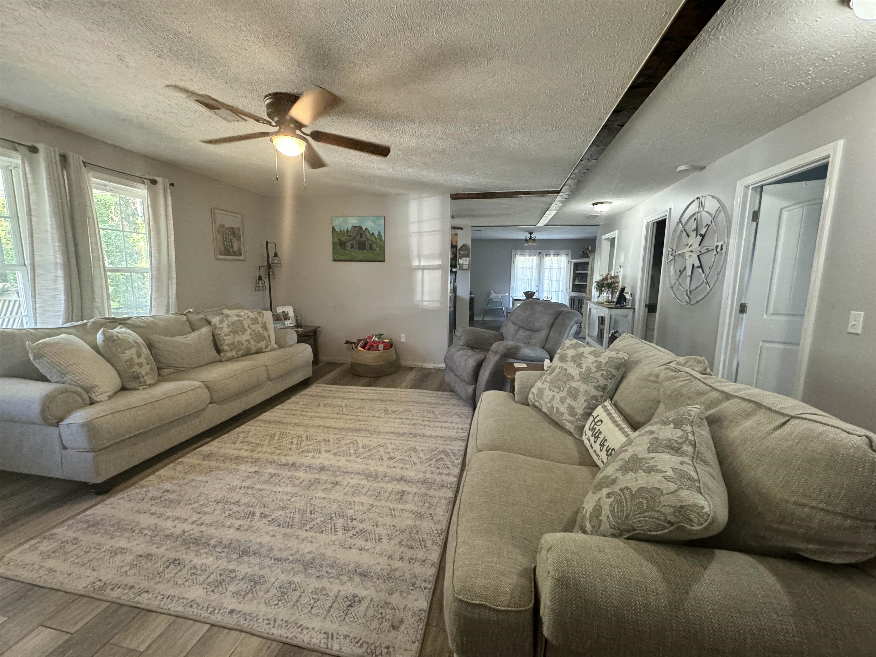 780 Ammons Road Selmer, TN 38375 - Photo 3 of 21 Living room featuring a textured ceiling, hardwood / wood-style flooring, and ceiling fan