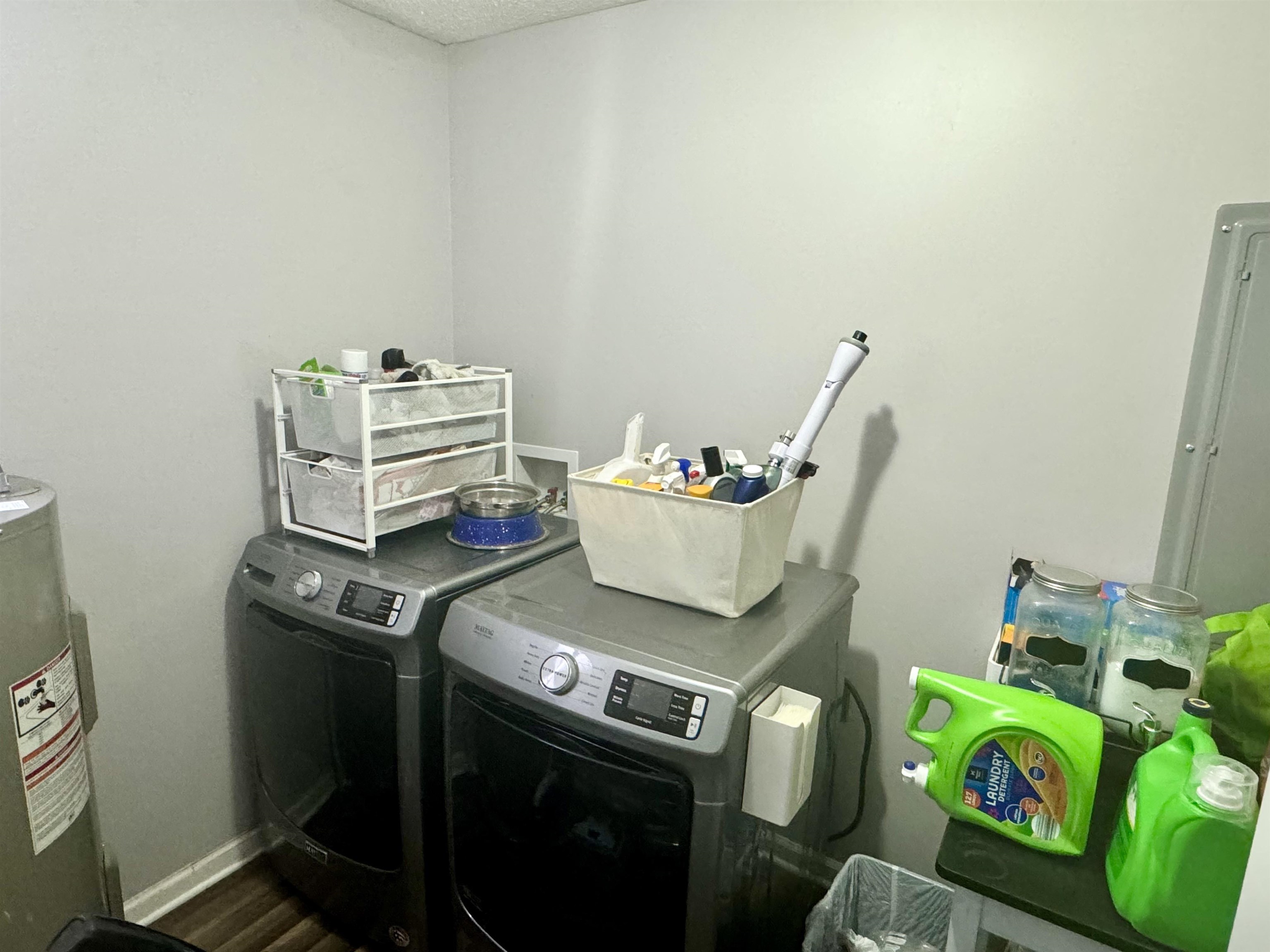 780 Ammons Road Selmer, TN 38375 - Photo 8 of 21 Washroom with electric water heater, hardwood / wood-style flooring, and washer and dryer