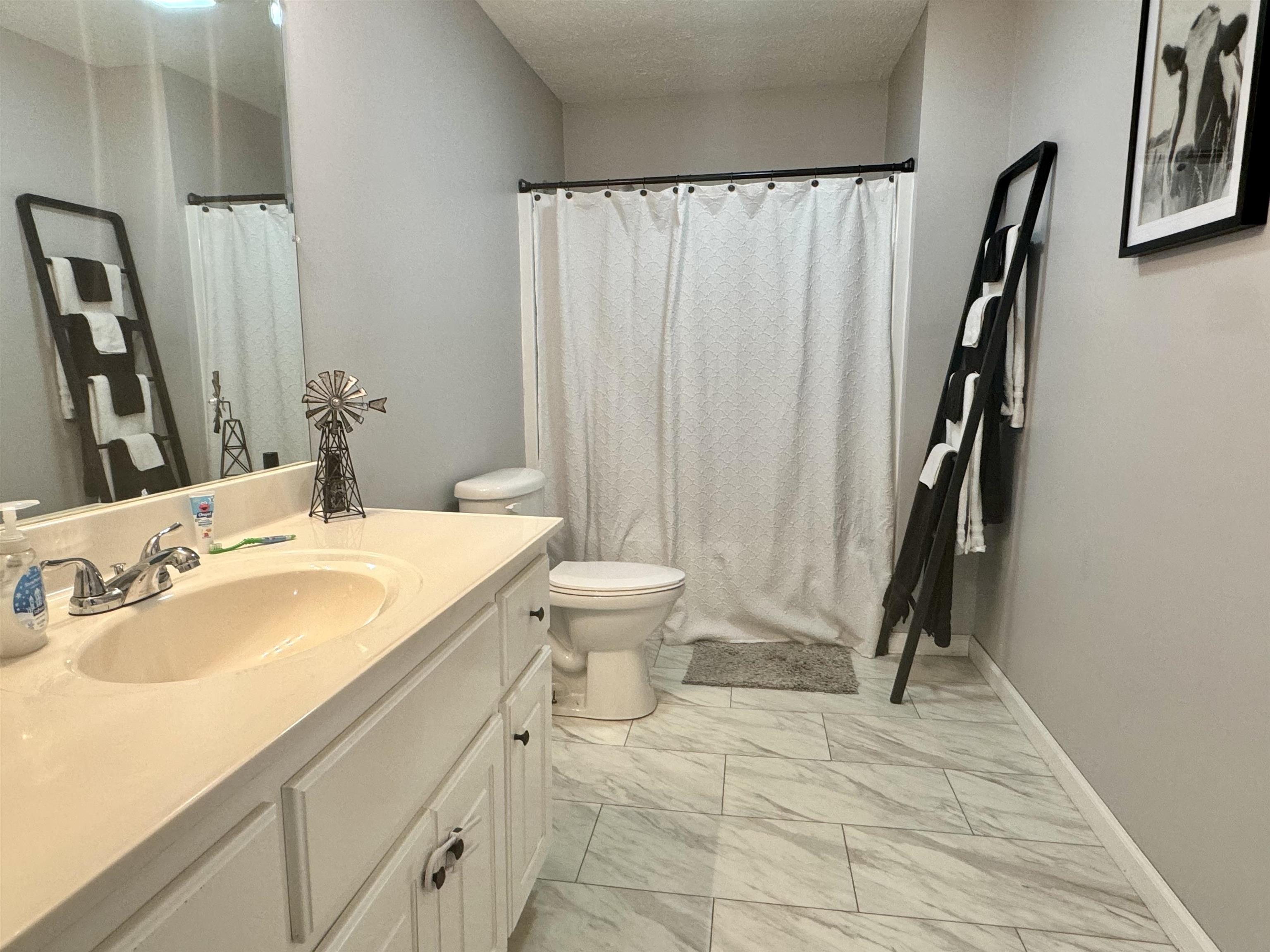 780 Ammons Road Selmer, TN 38375 - Photo 10 of 21 Bathroom with tile patterned flooring, toilet, and vanity