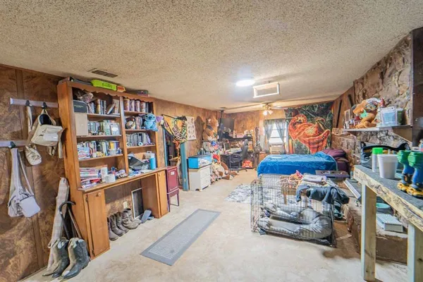 a living room with lots of furniture and a book shelf