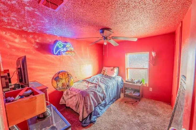 a bed room with a bed and a lamp