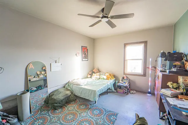 a bedroom with bed and a window