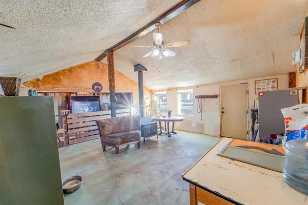 a living room with furniture and a dining table