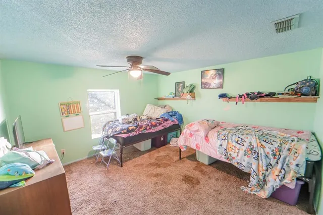 a bedroom with a bed and a table