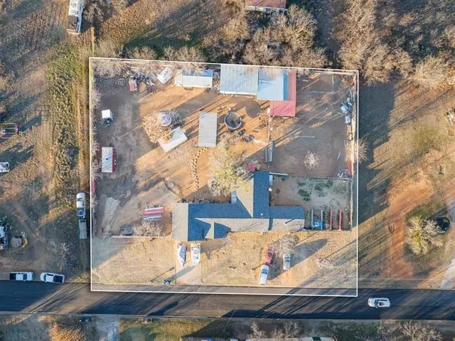 a view of a house with snow on the side of road