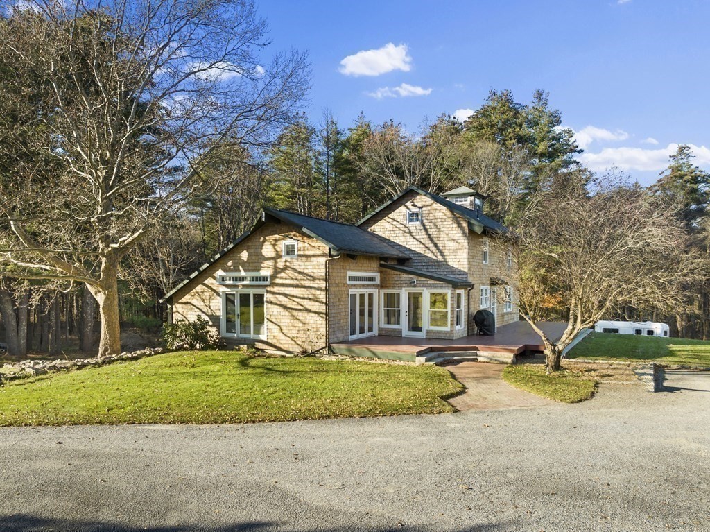 48 Lincoln Road Wayland, MA 01778 - Photo 3 of 11 a house that has a tree in front of it