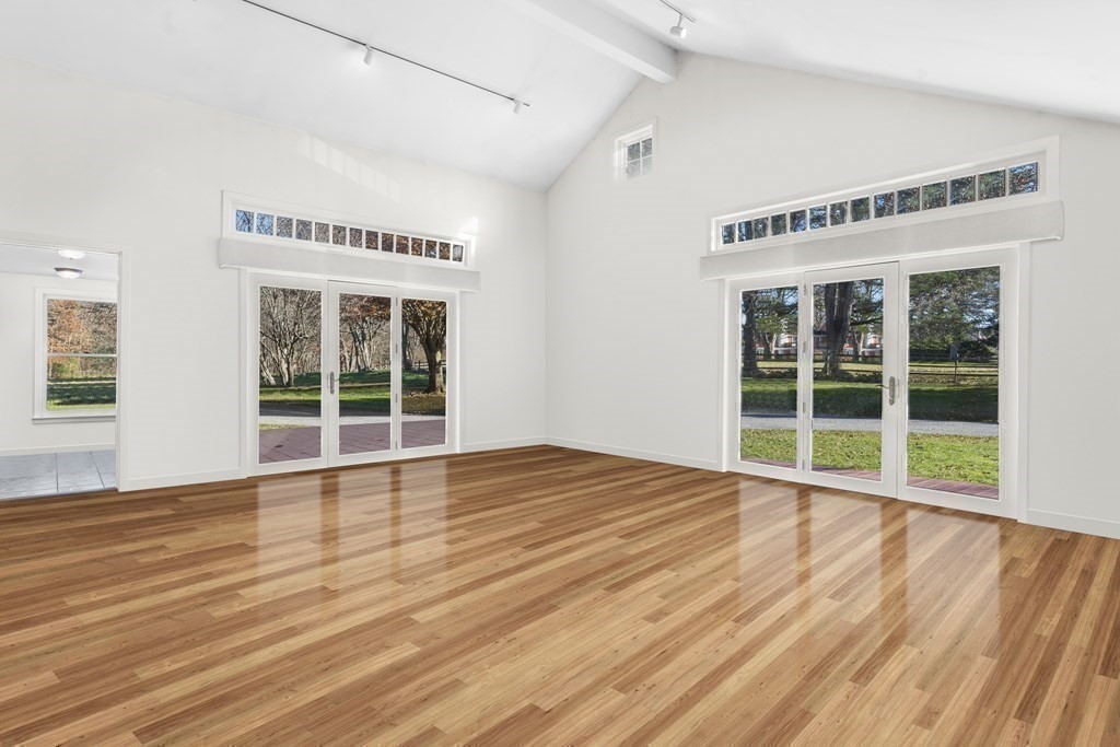 48 Lincoln Road Wayland, MA 01778 - Photo 5 of 11 a view of an empty room with wooden floor and windows