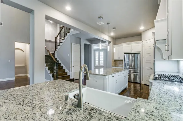 a large room with a large window and stainless steel appliances