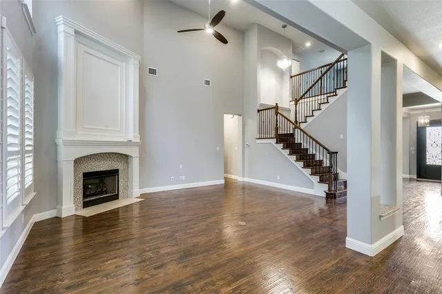 a view of a livingroom with wooden floor and a fireplace